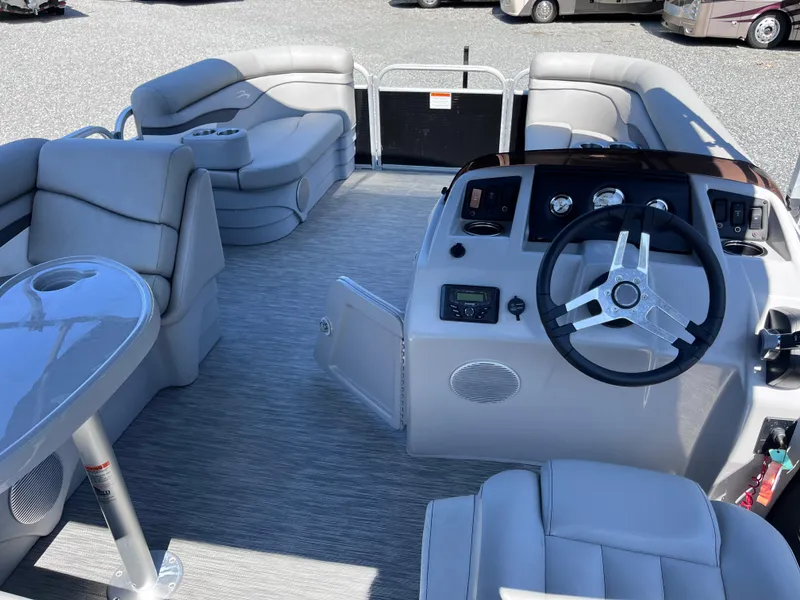 Slide: The Image of 2021 Bennington SV 20 Quad Bench pontoon boat interior with steering console and seating. - 6