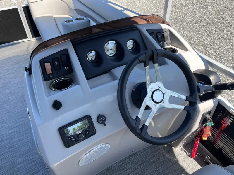Slide: The Image of 2021 Bennington SV 20 Quad Bench boat dashboard with steering wheel and controls. - 7