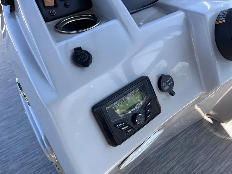 Slide: The Image of 2021 Bennington SV 20 Quad Bench dashboard with control panel and cup holder. - 8