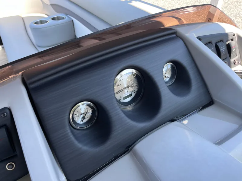 Slide: The Image of Dashboard of 2021 Bennington SV 20 Quad Bench boat with gauges and cup holders. - 9