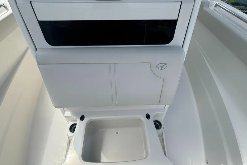 Slide: The Image of 2025 Sailfish 312 CC boat interior with storage compartment and cup holders. - 15