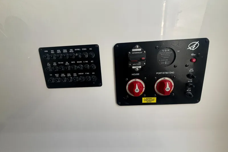 Slide: The Image of Control panel of 2025 Sailfish 312 CC boat with switches and dials. - 20