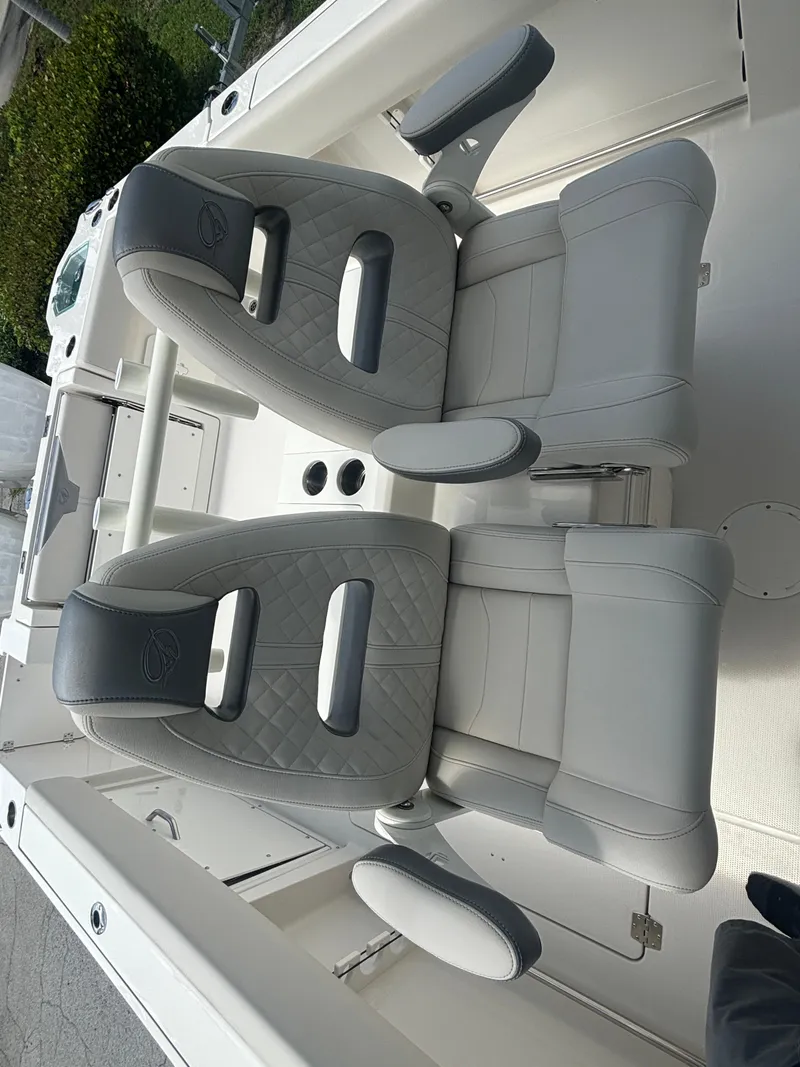 Slide: The Image of 2025 Sailfish 312 CC boat interior with two gray cushioned seats. - 22