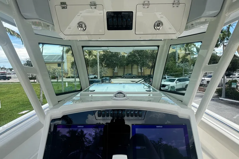 Slide: The Image of Interior view of 2025 Sailfish 312 CC boat cockpit with modern navigation displays. - 23