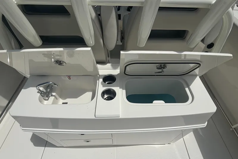 Slide: The Image of Sailfish 312 CC 2025 boat interior with sink and storage compartments. - 27