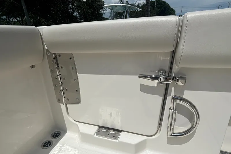 Slide: The Image of 2025 Sailfish 312 CC boat interior with stainless steel latch and padded seating. - 31