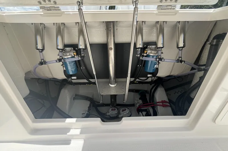 Slide: The Image of 2025 Sailfish 312 CC boat engine compartment with hydraulic systems and wiring. - 32