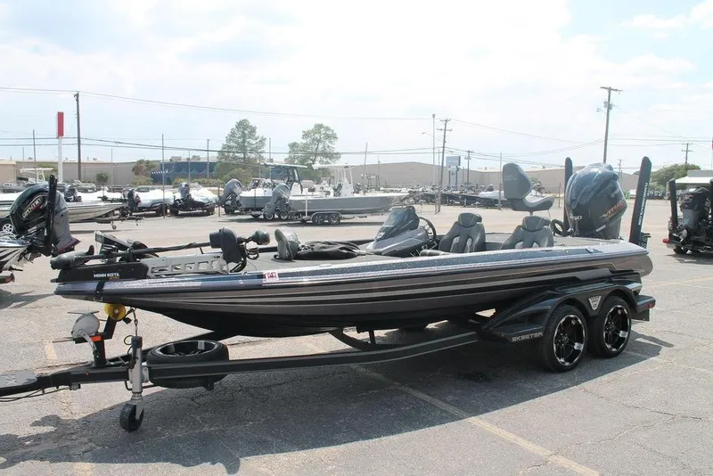 Slide: The Image of 2018 Skeeter FX20 Limited Edition boat in parking lot, featuring sleek design and dual motors. - 7