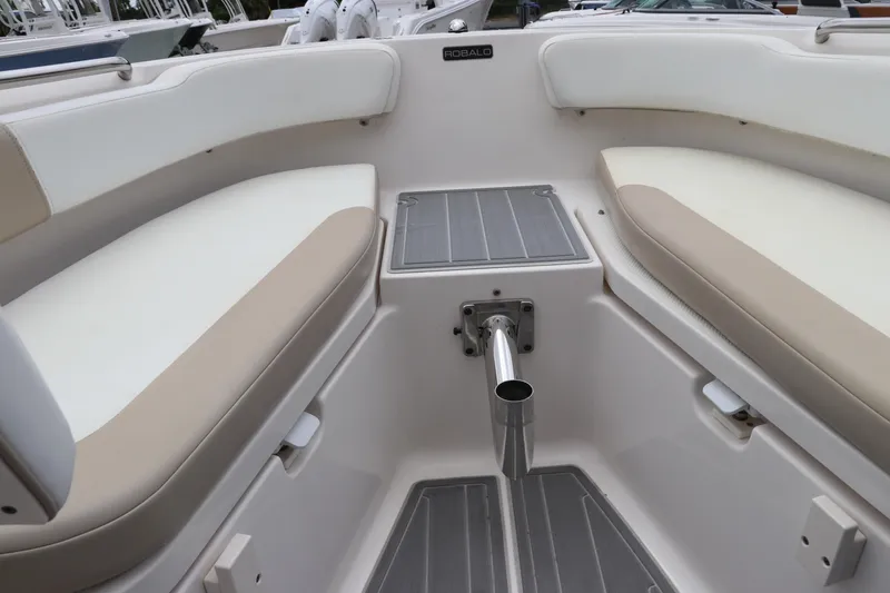 Slide: The Image of 2018 Robalo R202 Explorer boat interior with cushioned seating and storage. - 10