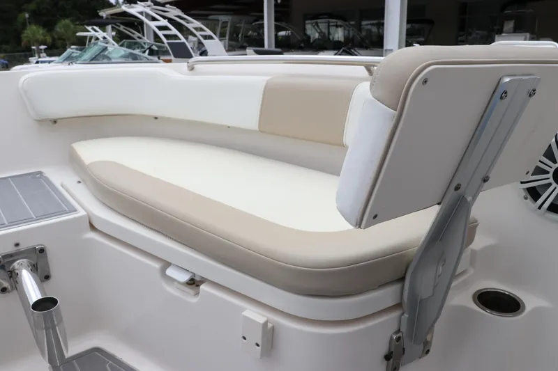Slide: The Image of 2018 Robalo R202 Explorer boat seating area with beige and white cushions. - 11