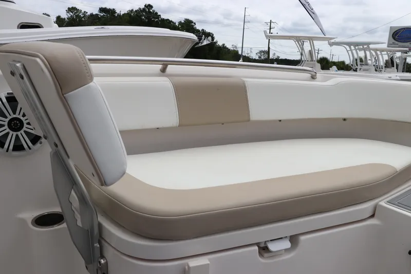 Slide: The Image of 2018 Robalo R202 Explorer boat seating area with beige and white upholstery. - 12