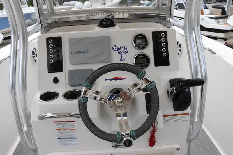 Slide: The Image of 2018 Robalo R202 Explorer boat dashboard with Garmin navigation system and steering wheel. - 3