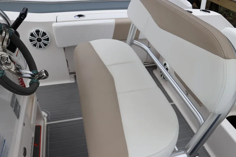 Slide: The Image of 2018 Robalo R202 Explorer boat interior with beige and white seating. - 5