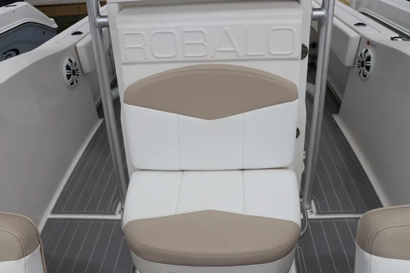 Slide: The Image of 2018 Robalo R202 Explorer boat seat with beige and white upholstery. - 7