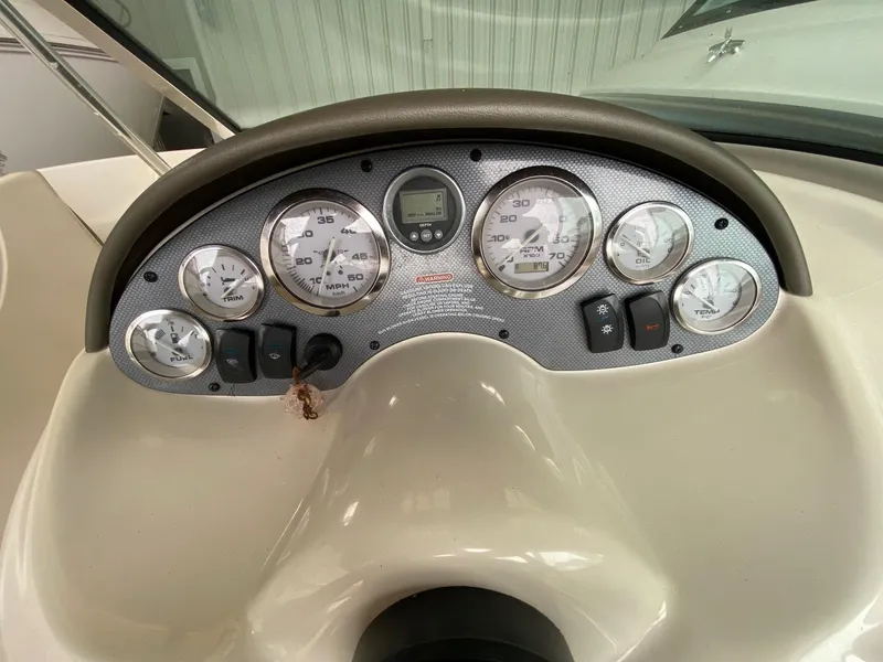 Slide: The Image of Dashboard of a 2005 Sea Ray 180 Sport boat with gauges and controls. - 3