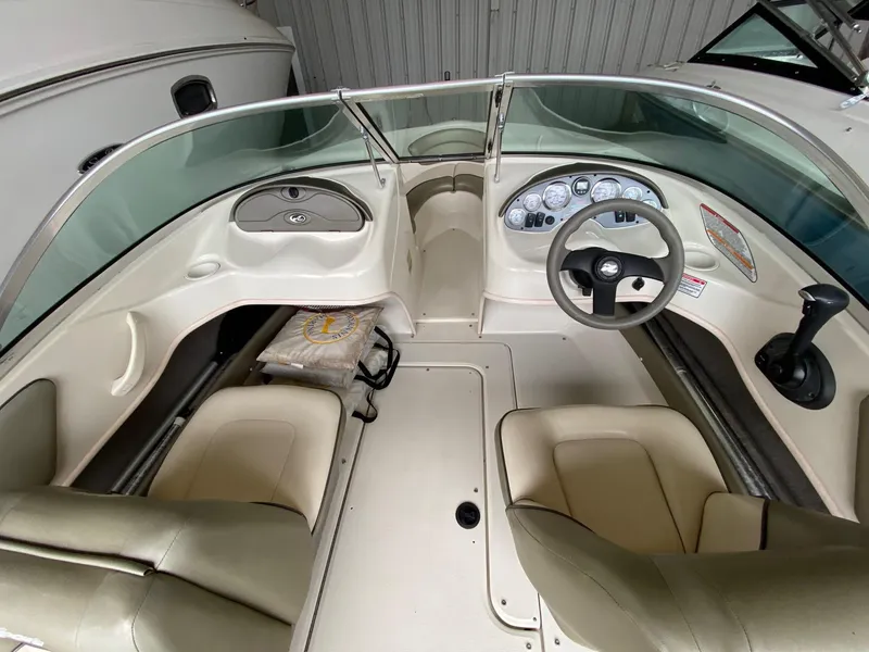 Slide: The Image of 2005 Sea Ray 180 Sport boat interior with steering wheel and dashboard controls. - 6