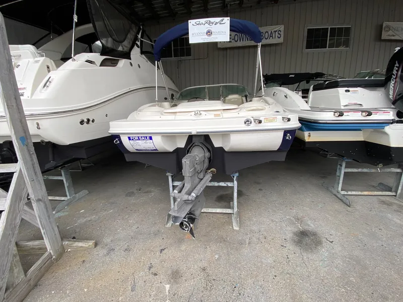 Slide: The Image of 2005 Sea Ray 180 Sport boat for sale, displayed in a marina showroom. - 7