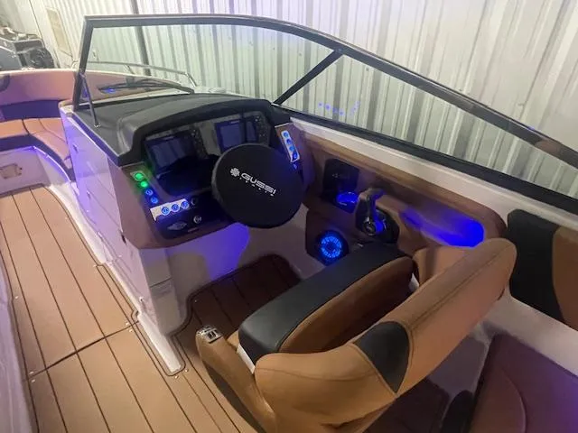Slide: The Image of 2025 Chaparral 30 Surf boat interior with modern dashboard and seating. - 11