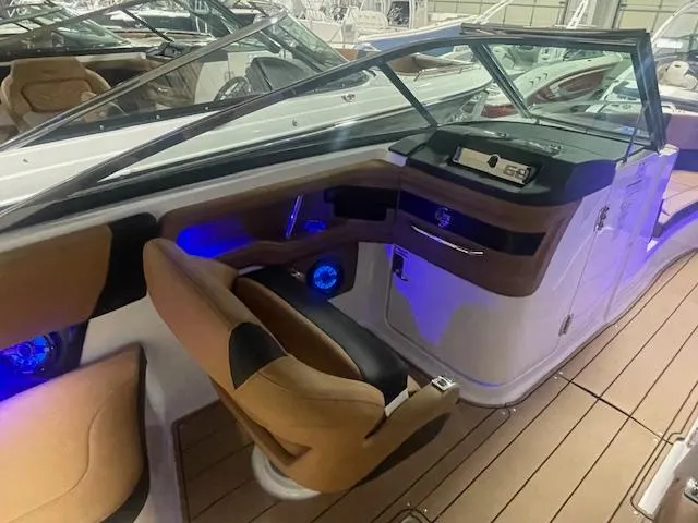 Slide: The Image of 2025 Chaparral 30 Surf boat interior with modern dashboard and ambient lighting. - 12