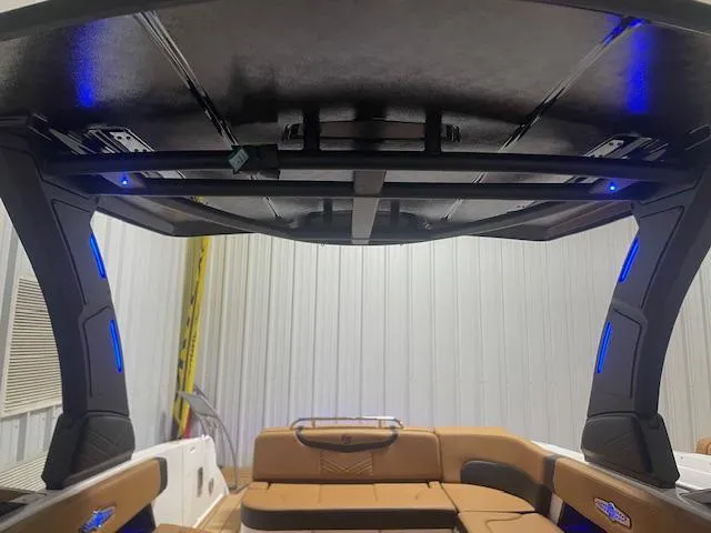 Slide: The Image of 2025 Chaparral 30 Surf boat interior with modern seating and illuminated canopy. - 15