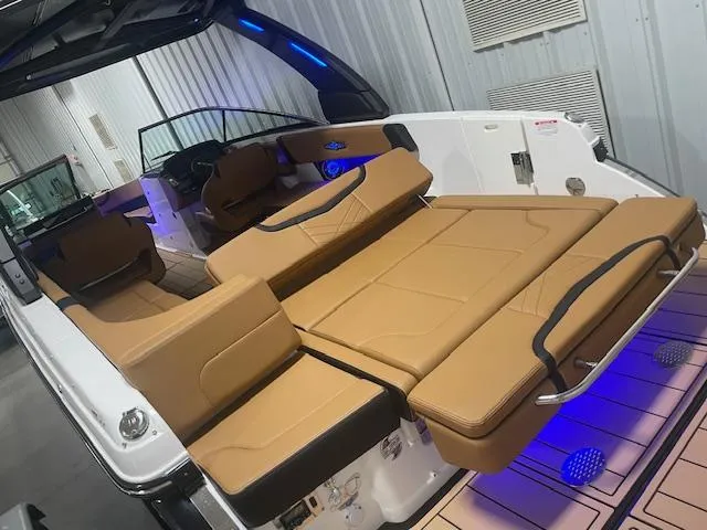 Slide: The Image of 2025 Chaparral 30 Surf boat interior with tan leather seating and modern design. - 7