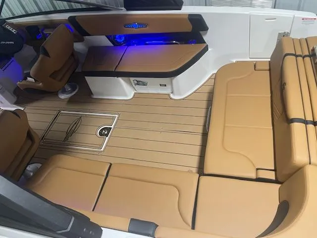 Slide: The Image of Luxurious interior of 2025 Chaparral 30 Surf boat with tan seating and blue LED lighting. - 8