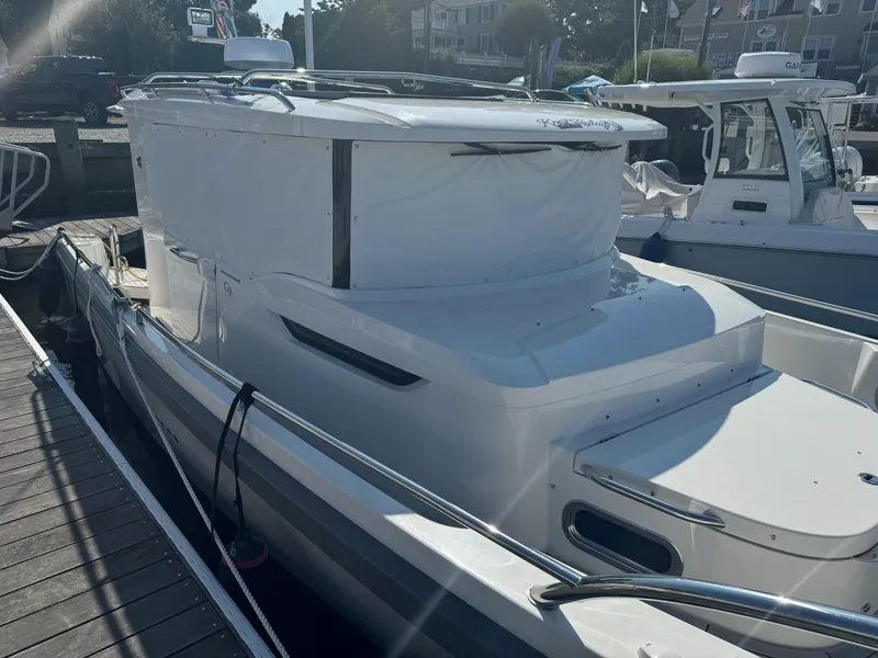 Slide: The Image of 2024 Nimbus Commuter 9 boat docked in marina, side view. - 3