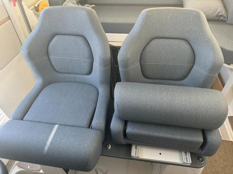 Slide: The Image of 2024 Nimbus Commuter 9 boat seats, gray upholstery, modern design. - 6