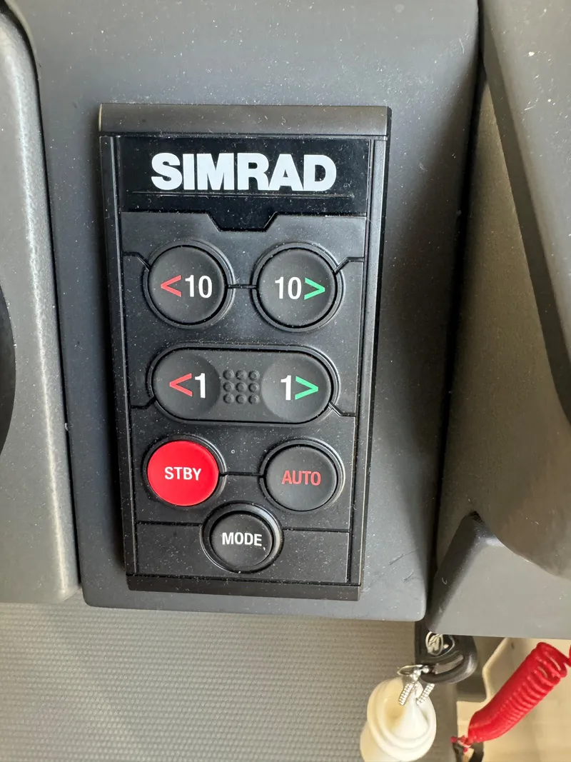 Slide: The Image of Simrad control panel in 2024 Nimbus Commuter 9 boat, featuring buttons for navigation and mode settings. - 9