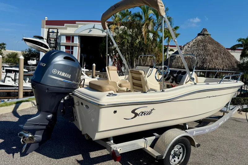 Slide: The Image of 2024 Scout 175 Sport Dorado boat with Yamaha engine on trailer, parked outdoors. - 3