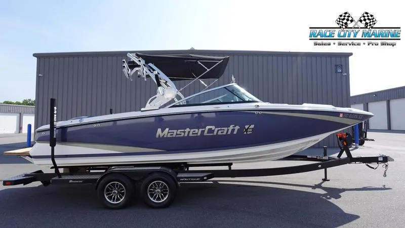 The Image of 2015 MasterCraft X55 boat on trailer at Race City Marine dealership. - 0