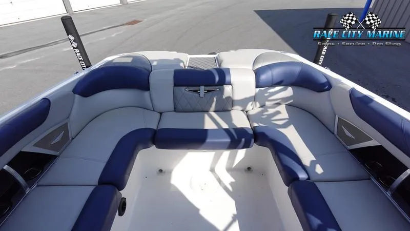 Slide: The Image of 2015 MasterCraft X55 boat interior with blue and white seating, Race City Marine logo. - 10