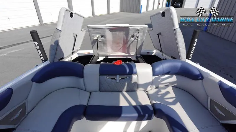 Slide: The Image of 2015 MasterCraft X55 boat interior with blue and white seating at Race City Marine. - 11