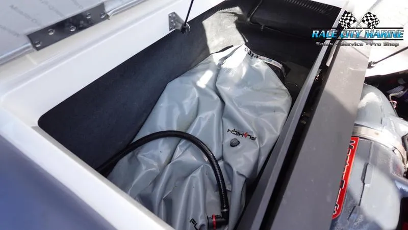 Slide: The Image of MasterCraft X55 2015 boat storage compartment with ballast bag and hose. - 14