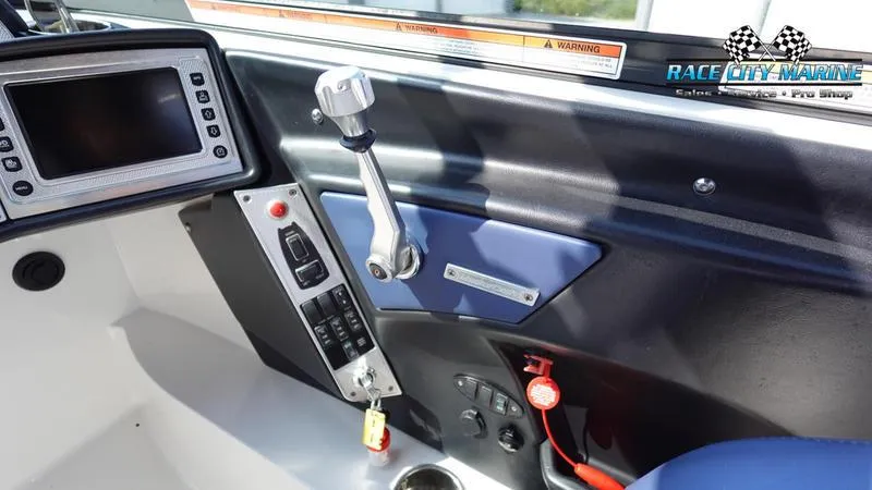 Slide: The Image of 2015 MasterCraft X55 boat control panel with throttle and navigation screen. - 23