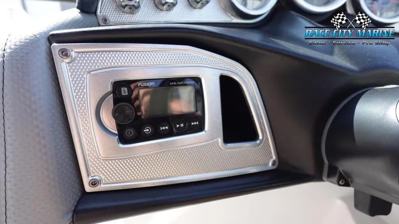 Slide: The Image of MasterCraft X55 2015 dashboard with Fusion audio system, Race City Marine branding. - 28