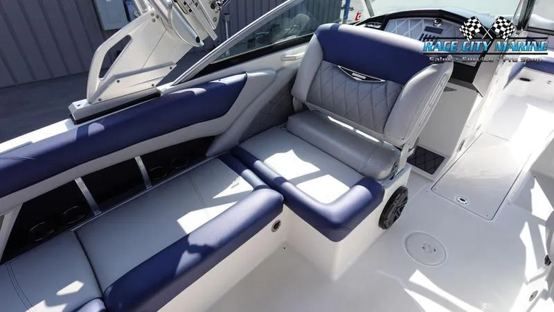 Slide: The Image of 2015 MasterCraft X55 boat interior with blue and white seating, Race City Marine logo visible. - 31
