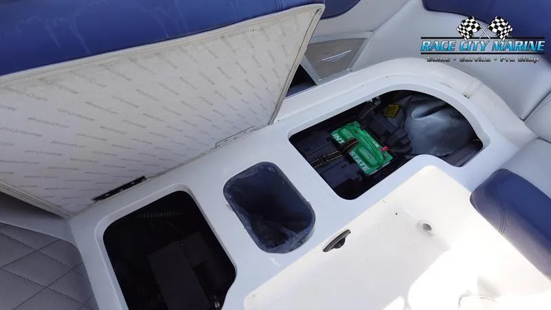 Slide: The Image of 2015 MasterCraft X55 boat storage compartment with battery and Race City Marine logo. - 34