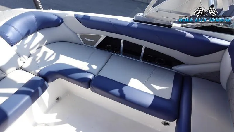 Slide: The Image of 2015 MasterCraft X55 boat interior with blue and white seating. - 35
