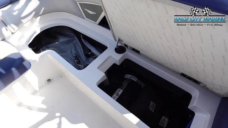 Slide: The Image of Open storage compartment in 2015 MasterCraft X55 boat interior. - 36