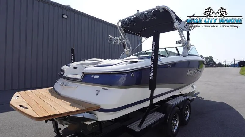 Slide: The Image of 2015 MasterCraft X55 boat on trailer at Race City Marine dealership. - 4