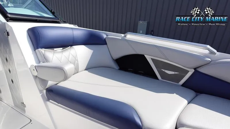 Slide: The Image of 2015 MasterCraft X55 boat interior with blue and white seating, Race City Marine logo. - 41