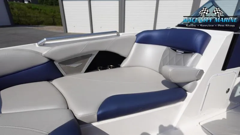 Slide: The Image of 2015 MasterCraft X55 boat interior with blue and white seating, Race City Marine logo. - 43