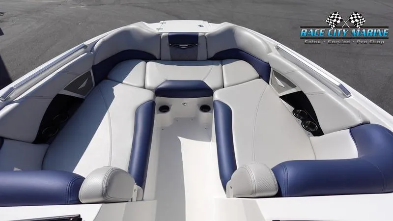 Slide: The Image of 2015 MasterCraft X55 boat interior with blue and white seating. - 46