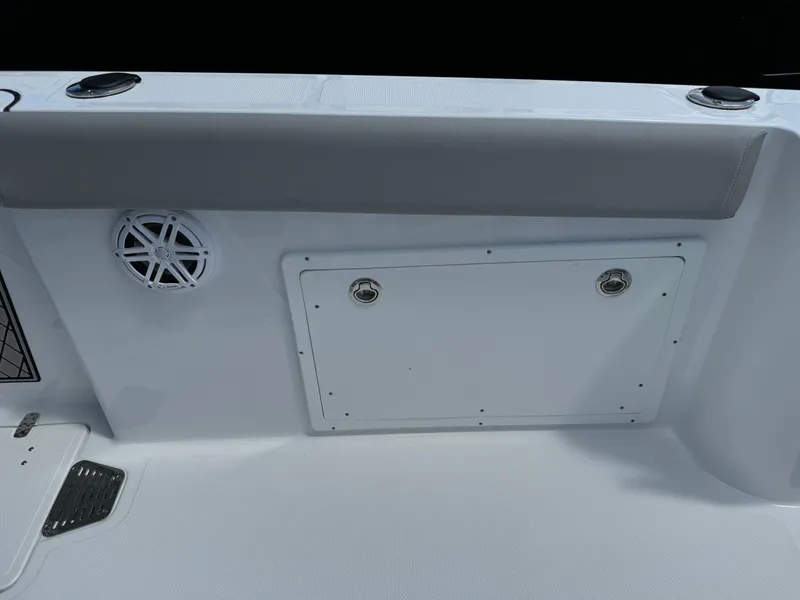 Slide: The Image of 2024 Wellcraft 262 Fisherman boat interior with speaker and storage compartment. - 15
