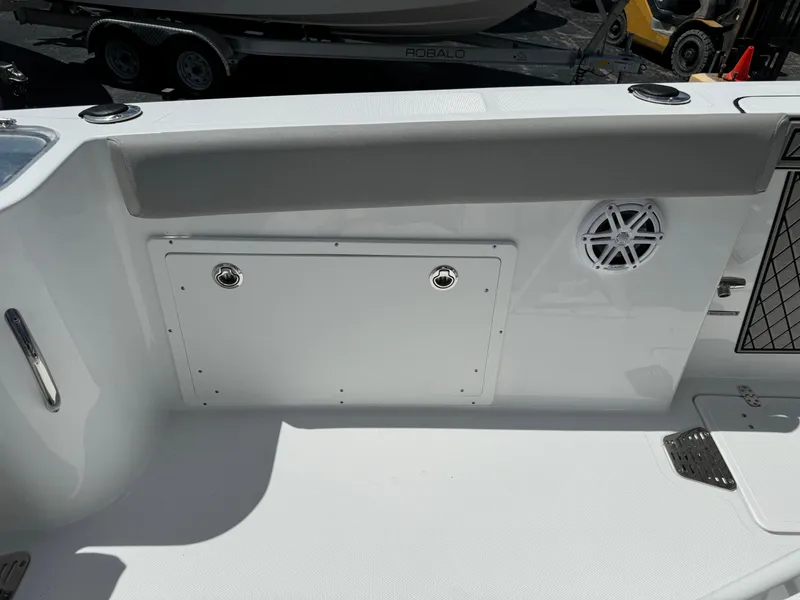 Slide: The Image of 2024 Wellcraft 262 Fisherman boat interior with storage compartment and speaker. - 16