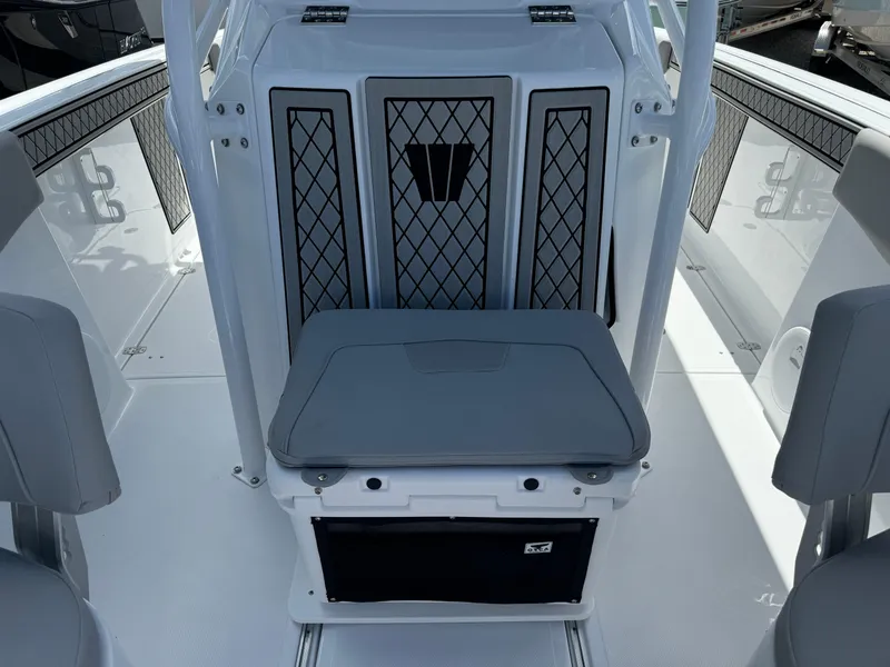 Slide: The Image of 2024 Wellcraft 262 Fisherman boat interior with cushioned seating and storage. - 21