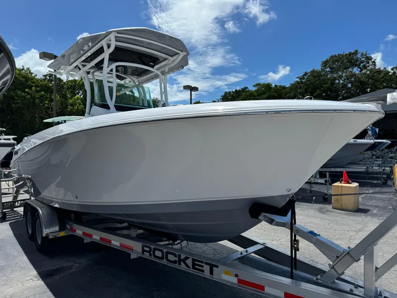 Slide: The Image of 2024 Wellcraft 262 Fisherman boat on trailer under clear blue sky. - 3