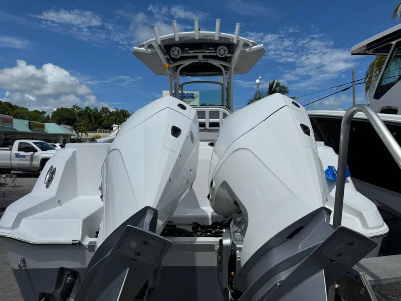 Slide: The Image of 2024 Wellcraft 262 Fisherman boat with dual outboard engines under a clear blue sky. - 4