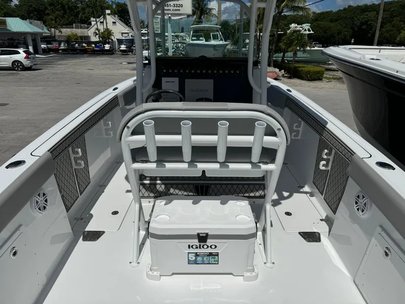 Slide: The Image of 2024 Wellcraft 262 Fisherman boat interior with rod holders and Igloo cooler. - 7